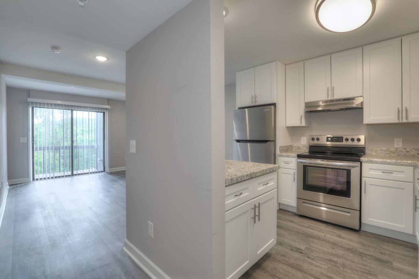 A kitchen with white cabinets and stainless steel appliances.